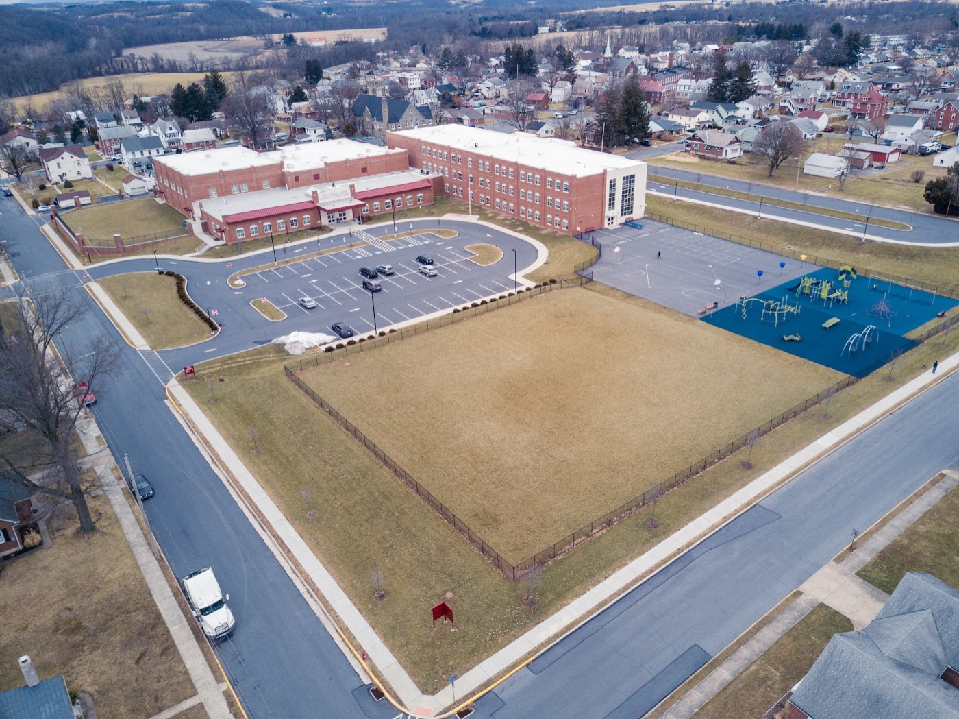 Aerial overview of a school campus and surrounding neighborhood